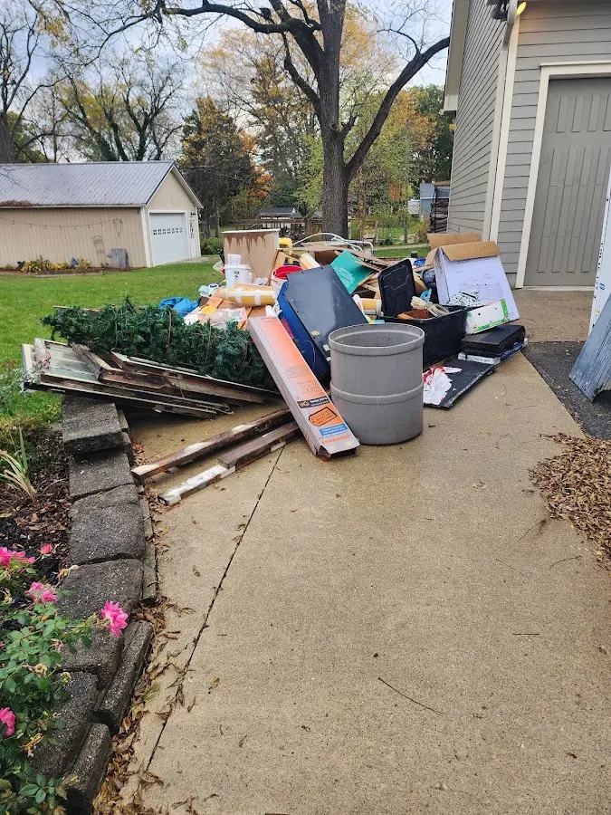 Dumpster being loaded with debris for 30 Yard Dumpster Rental in Flemington
